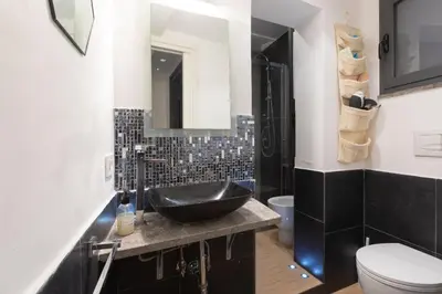 a bathroom with a black sink and a toilet at Vicolo Navona in Rome