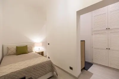 a white bedroom with a bed and a closet at Lovely New home, Trastevere! in Rome