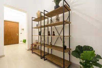 a room with wooden shelves on the wall at Lovely New home, Trastevere! in Rome
