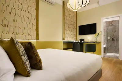 a hotel room with a bed and a desk at Velantia Vaticano - Guesthouse in Rome