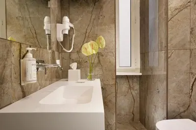a bathroom with a white sink and a white cabinet at Velantia Vaticano - Guesthouse in Rome