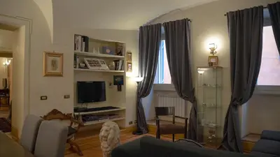 a living room with a couch and a tv at MGPGroup Guest House Navona in Rome
