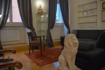 a living room with a lion statue in the middle at MGPGroup Guest House Navona in Rome