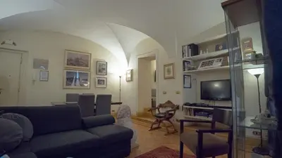 a living room with a couch and a tv at MGPGroup Guest House Navona in Rome