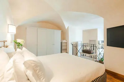 a bedroom with a bed and a flat screen tv at Teichnersuite in Rome