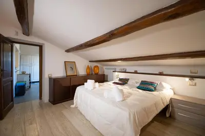 a bedroom with a large bed with white sheets and pillows at CasaJusta Trastevere in Rome