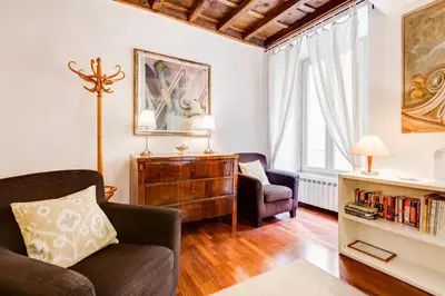a living room with a couch and a chair at Diana-Spanish Steps House in Rome