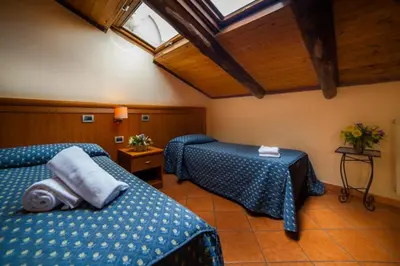 a hotel room with two beds and a roof at Nights In Rome in Rome