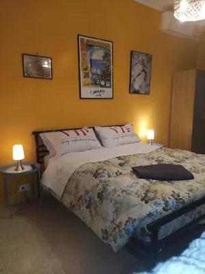 a bed in a bedroom with two lamps and a bedspread at roma capoccia b&b in Rome