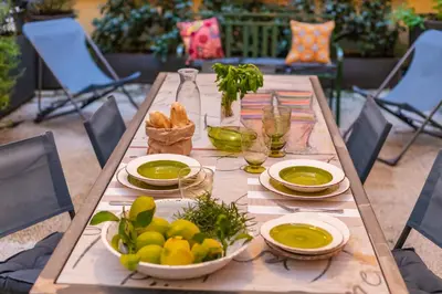 a wooden table with plates and bowls of food on it at Casa Frisi in Rome
