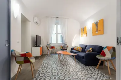 a living room with a blue couch and chairs at Casa Frisi in Rome
