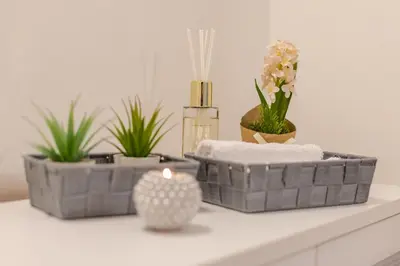 three baskets sitting on a counter with plants and a candle at Casa Frisi in Rome