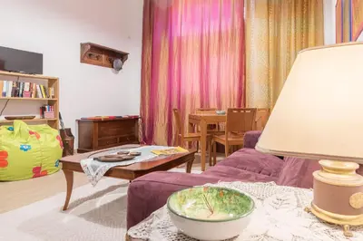 a living room with a purple couch and a table at GuestHost - Monti Artistic Flat in Rome