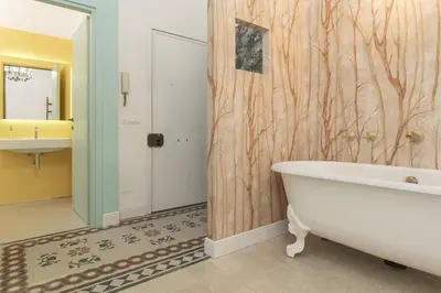 a bathroom with a bath tub and a sink at Romantic Vintage Colosseum Suite in Rome