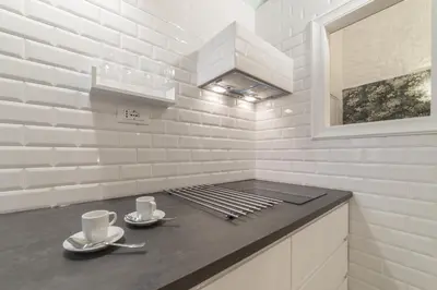 a kitchen with two coffee cups on a counter at Romantic Vintage Colosseum Suite in Rome