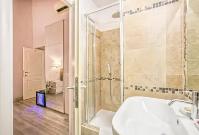 a bathroom with a shower and a tub and a sink at History Suite in Rome