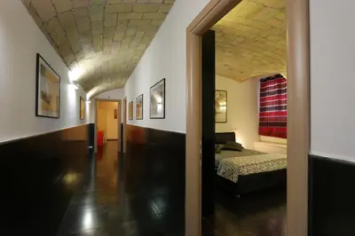 a hallway leading to a bedroom with a bed in a room at Residenza Adriana in Rome