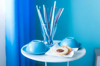 a plate with two pastries and a vase on a table at Quelli della via Gluck in Rome