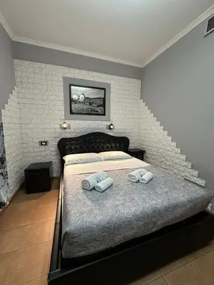 a bedroom with a bed with two towels on it at Double B in Rome