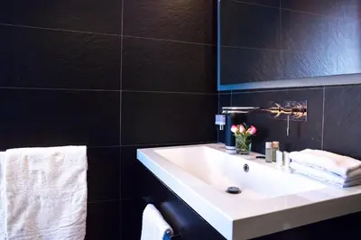a bathroom with a white sink and a mirror at Rent in Rome - IV Novembre in Rome