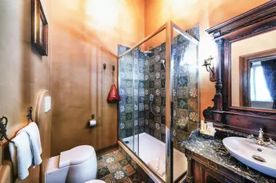 a bathroom with a shower and a toilet and a sink at Navona Grand Suite in Rome