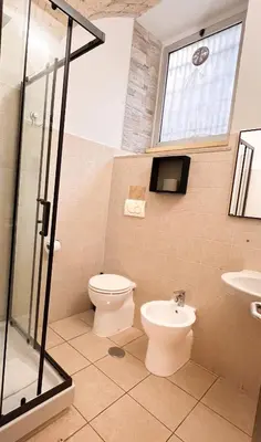 a bathroom with a toilet and a sink at Saint Peter Loft in Rome