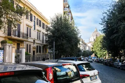 a street with cars parked on the side of the road at Saint Peter Loft in Rome