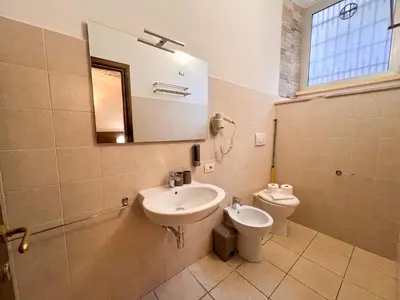 a bathroom with a sink and a toilet at Saint Peter Loft in Rome