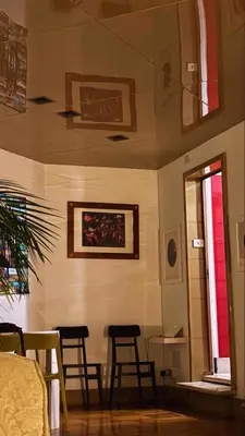 a room with chairs and a table and a window at La Terrazza di Isabel in Rome