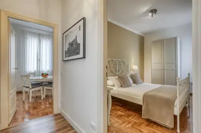 a bedroom with a bed and a table and a mirror at ATRHOME penthouse Frattina in Rome