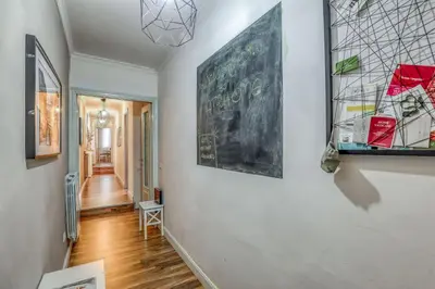 a hallway with paintings on the walls of a house at ATRHOME penthouse Frattina in Rome
