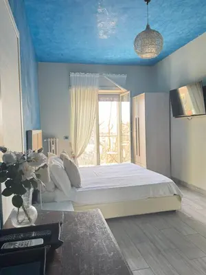 a bedroom with a bed and a bathroom with a sink at Stileroma in Rome
