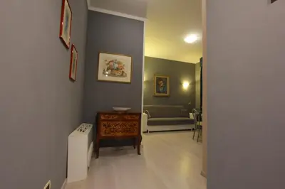 a hallway with a living room with a couch at VIA VENETO SUITE 104 in Rome
