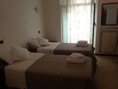 two beds in a hotel room with towels on them at B&B Missi in Rome
