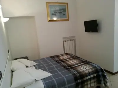a bedroom with a bed and a tv on the wall at B&B Missi in Rome