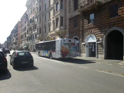 a bus is parked on the side of a city street at B&B Missi in Rome
