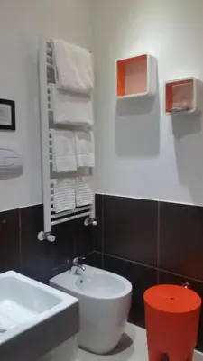 a bathroom with a white sink and a white toilet at InnVatican Guest House in Rome