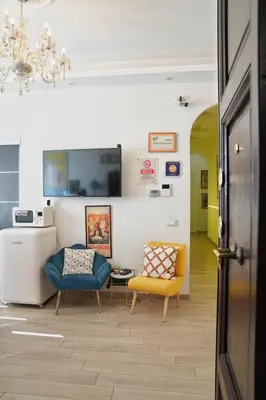 a living room with two chairs and a table at Archi di Roma Guest House in Rome