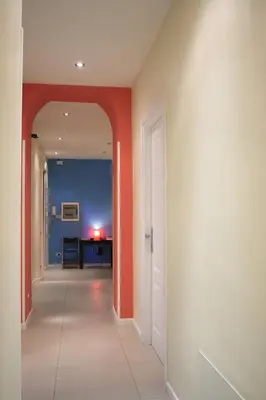 an empty hallway with orange walls and a room at Manin Suites LT in Rome
