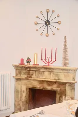 a fireplace with candles and a clock above it at Terrazza San Giovanni apartment in Rome