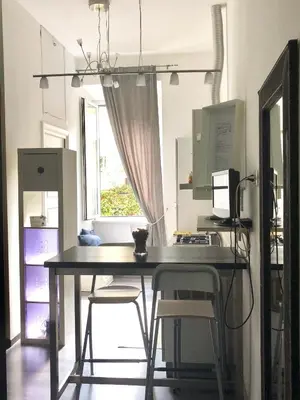 a desk with chairs and a computer on top of it at Luxy Vatican Apartment in Rome