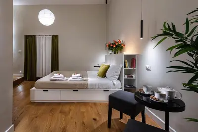 a bedroom with a bed and a table at Tula Inn in Rome