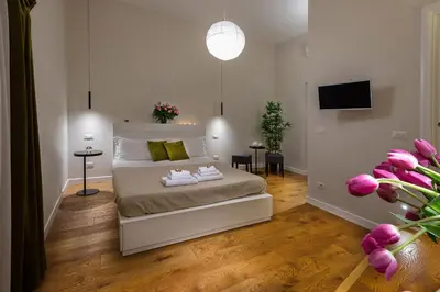 a bedroom with a bed with two towels on it at Tula Inn in Rome