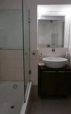 a bathroom with a sink and a tub and a mirror at Grotte Flat in Rome