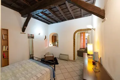 a bedroom with a bed and a living room at JUSTACASA alla SCALA Trastevere in Rome