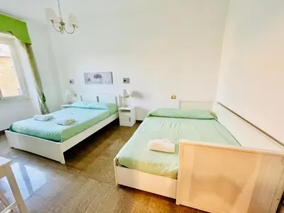 a bedroom with two beds and a table at INTERNO DIECI in Rome