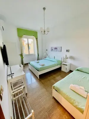 a room with two beds and a television in it at INTERNO DIECI in Rome