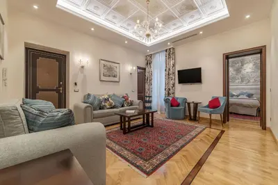 a living room with a couch and a table at 900 Apartments Veneto & Pinciana in Rome