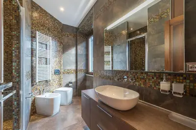 a bathroom with a sink and two toilets at 900 Apartments Veneto & Pinciana in Rome