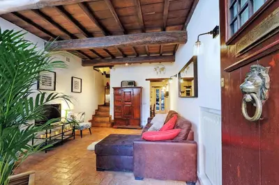 a living room with a couch with red pillows at San Callisto in Rome